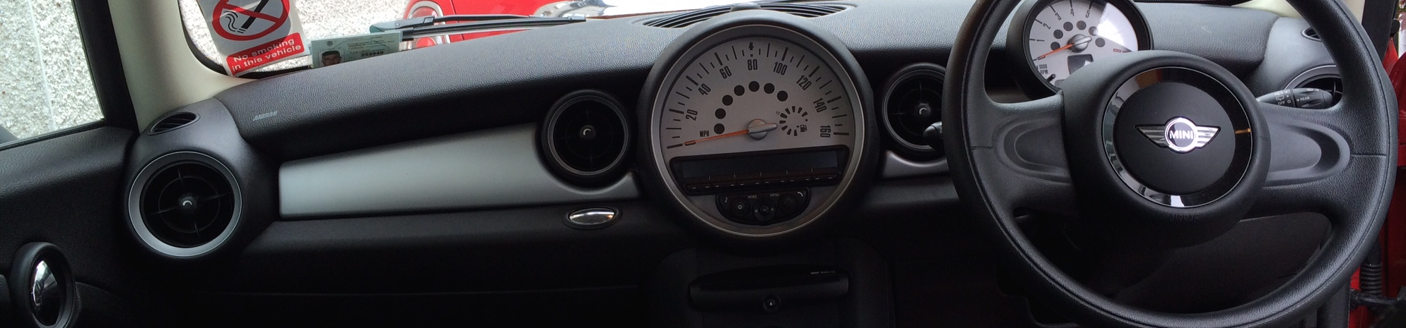 The dashboard and driving controls inside Mini Tuition's car